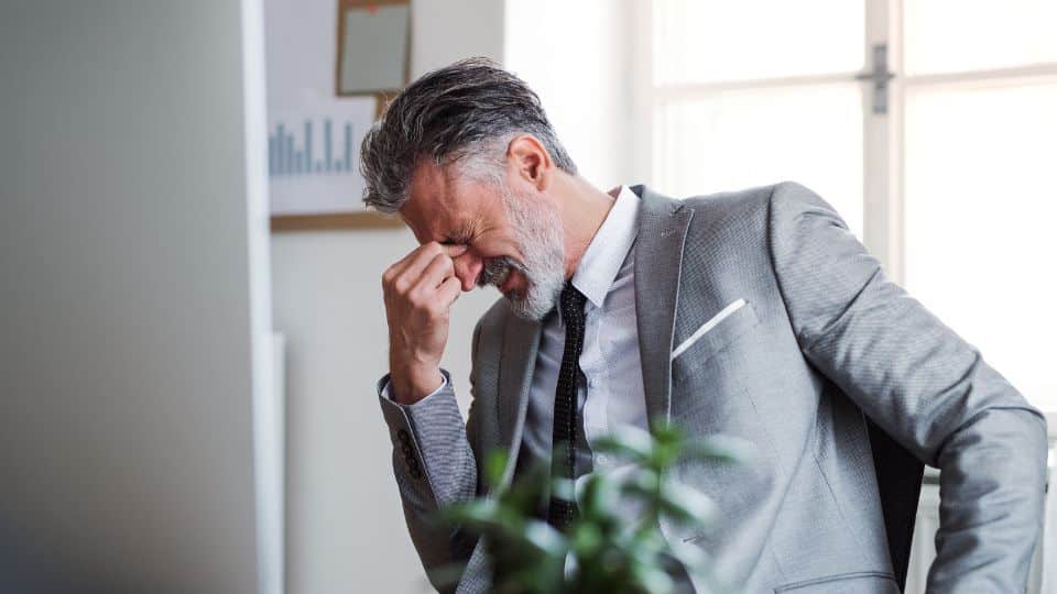 stressed man gray jacket sued